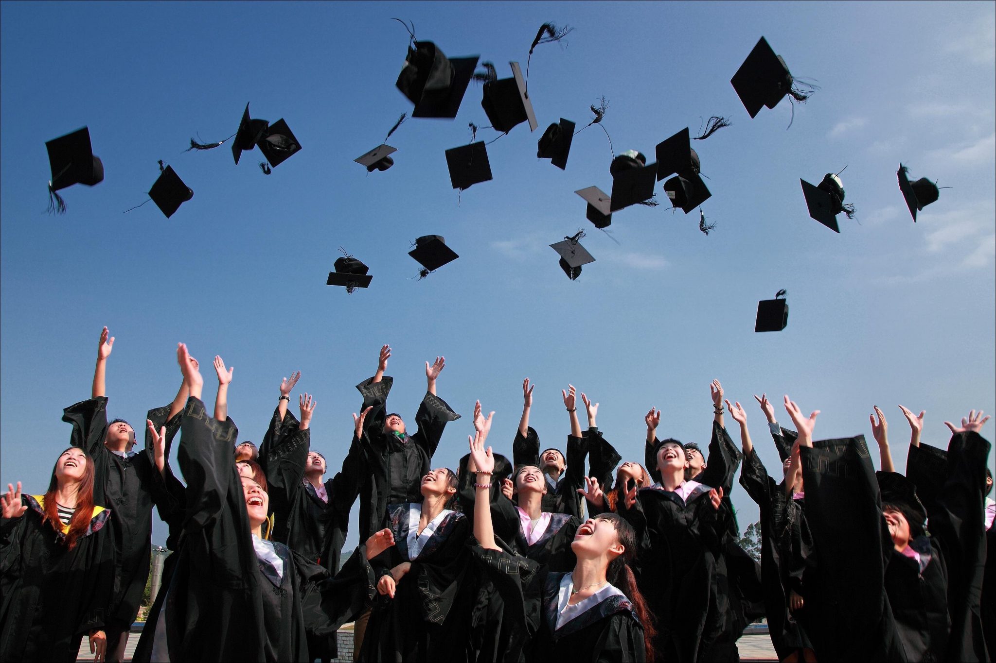 Graduation hats thrown in air