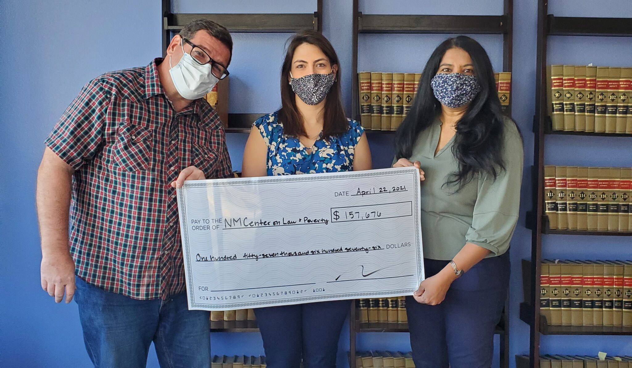 3 Adults Holding Large Check